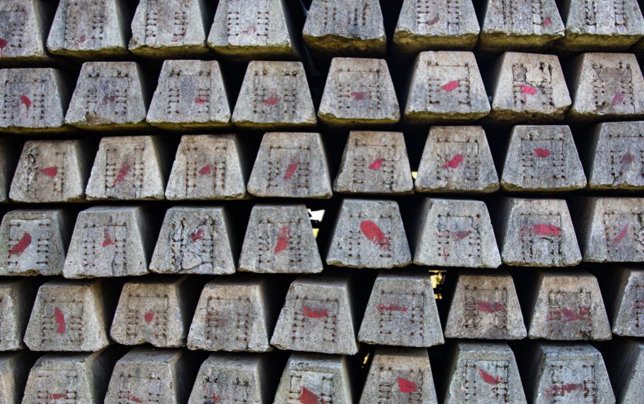 Close-up of stacked concrete blocks with red markings, showcasing industrial texture.